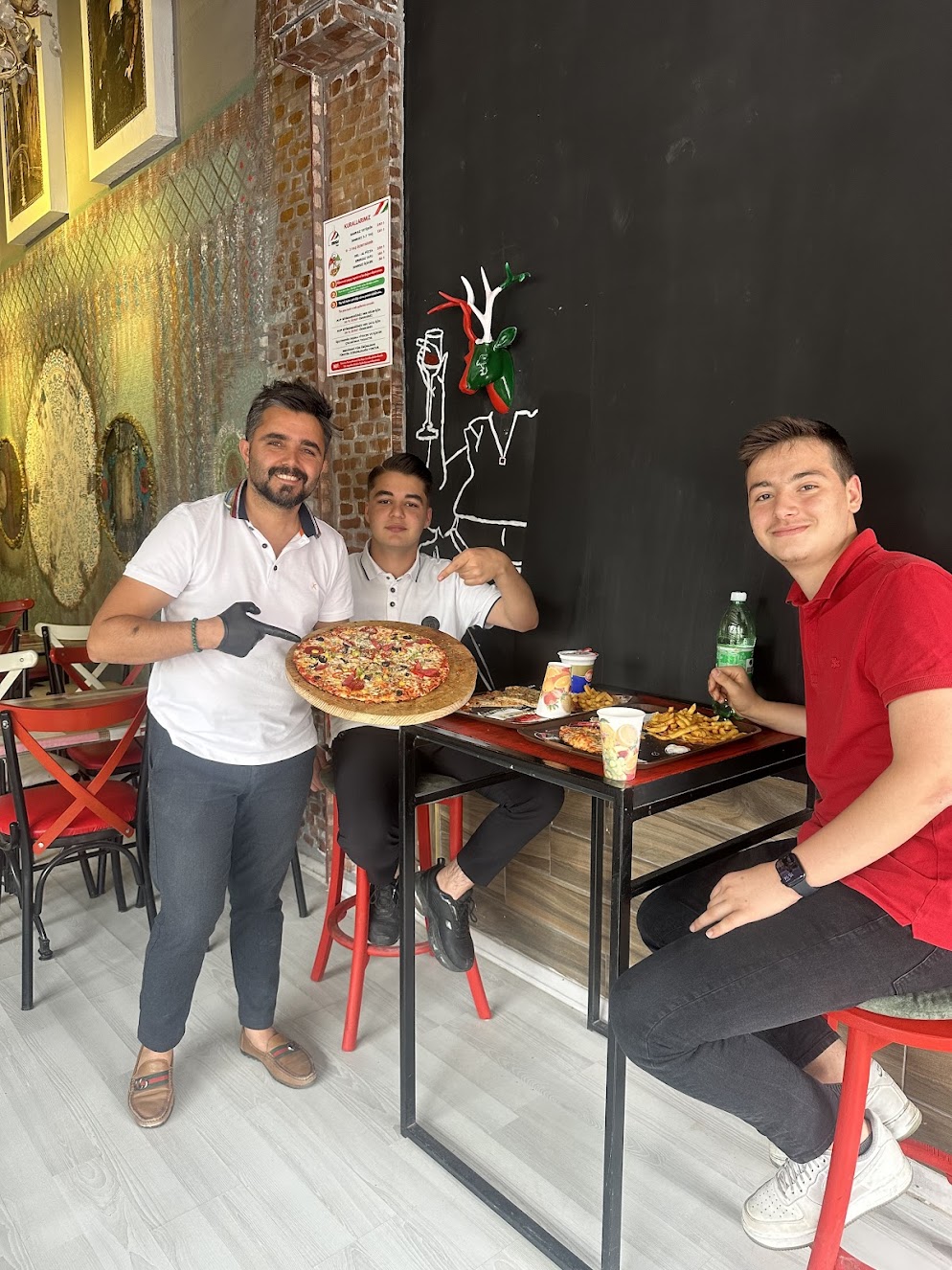 Happy customers enjoying their meal at Vanga Pizza